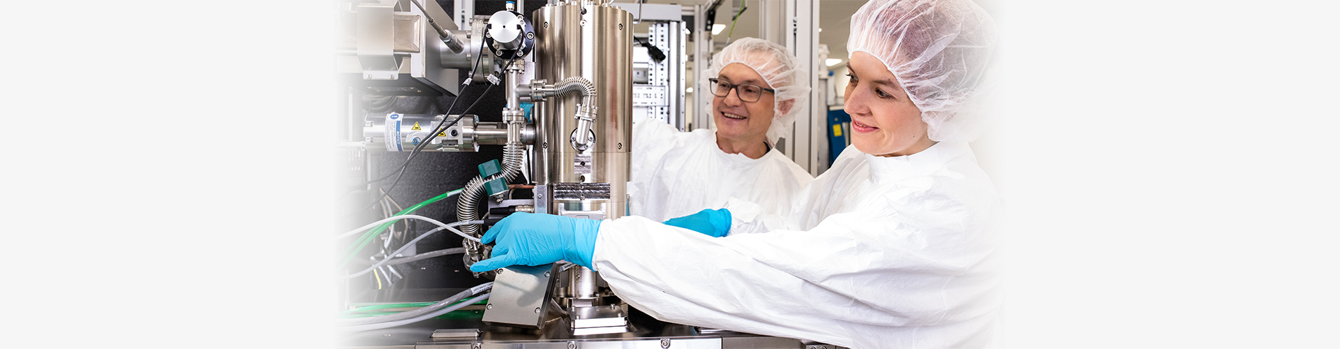 Photo of two Raith employyes working on a nanofabrication system